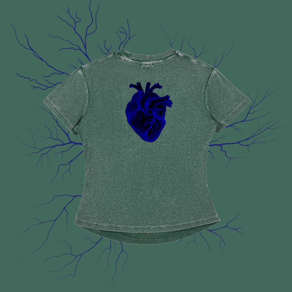 A short-sleeve t-shirt in a washed sage green color, featuring a detailed dark blue anatomical heart graphic on the chest. The shirt is displayed against a matching sage green background decorated with dark blue branching veins.