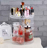 Clear cosmetic organizer with various items on a white surface and gray brick wall background