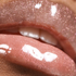 Close-up of a black woman lips with glittery lip gloss