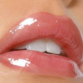 Close-up of glossy lips with a focus on texture and colour.