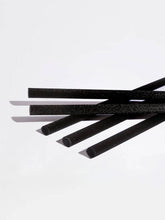 Five black foam straws with a textured surface, arranged diagonally on a clean white background.
