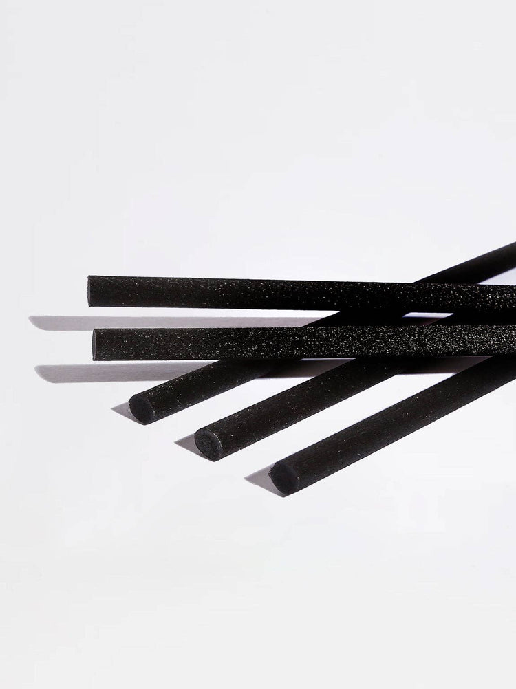 Five black foam straws with a textured surface, arranged diagonally on a clean white background.