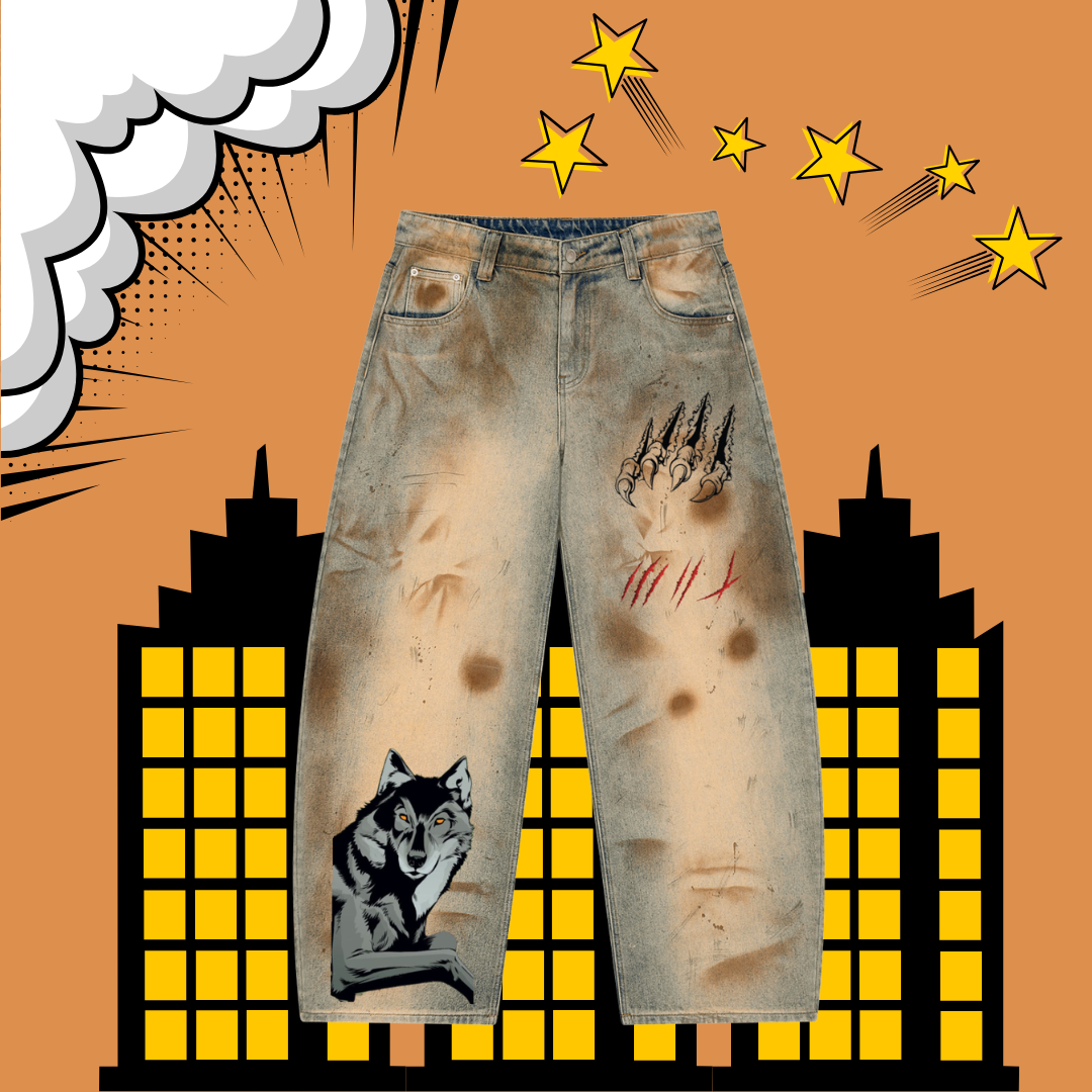 Distressed light-wash denim jeans with horror-themed graphic prints, including a wolf on one leg, claw marks on the other thigh, and red scratch marks, shown against a comic-style orange background with yellow stars and buildings.