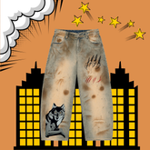Distressed light-wash denim jeans with horror-themed graphic prints, including a wolf on one leg, claw marks on the other thigh, and red scratch marks, shown against a comic-style orange background with yellow stars and buildings.