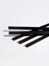 Five black foam straws with a textured surface, arranged diagonally on a clean white background.