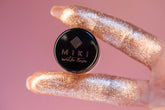 Hand holding a black container with &