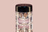 Makeup product with a metallic cap on a pink background