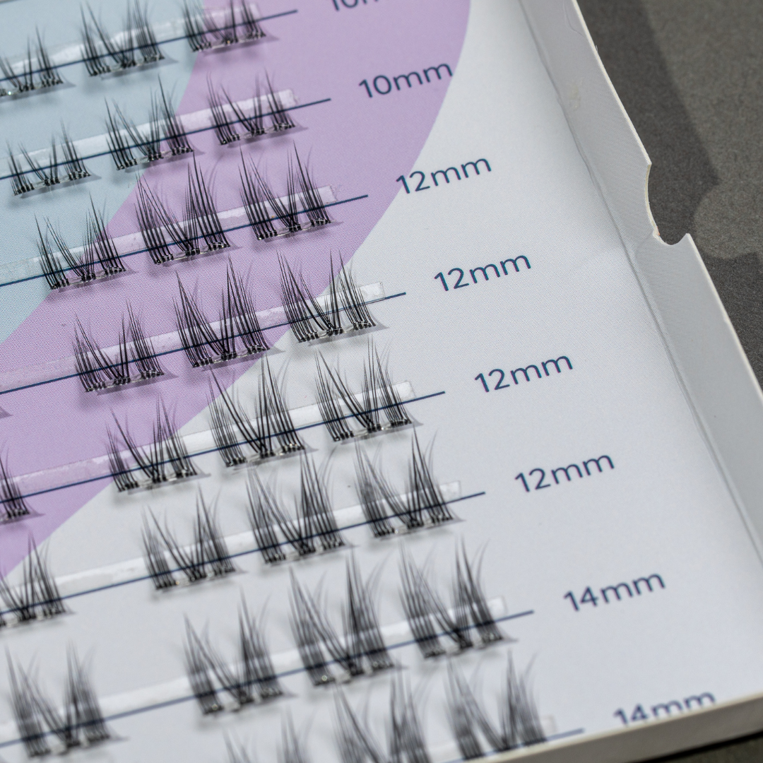 Set of false eyelashes with measurement markings on a tray