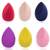Set of six colourful makeup sponges on a white background