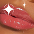 Close-up of glossy red lips with a sparkly finish on brown skin person.