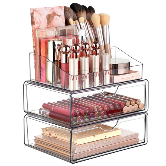 Clear makeup organizer with lipsticks, brushes, and other cosmetic items on a white background