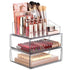 Clear makeup organizer with lipsticks, brushes, and other cosmetic items on a white background